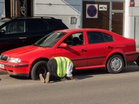 man-changing-punctured-tyre-red-car.jpg